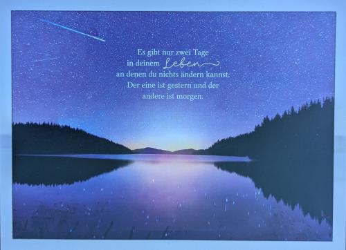 Mountain lake in the night with starry sky in the background