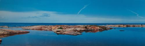 Panorama of a rocky beach in the Gulf of Finland in summer