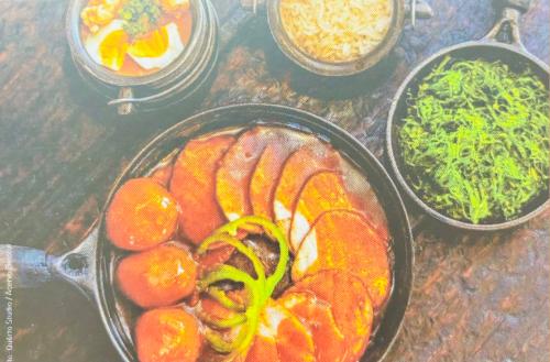 Top view of fresh fish soup with vegetables in a pot on the table Top view of fresh fish soup with vegetables in a pot on the table