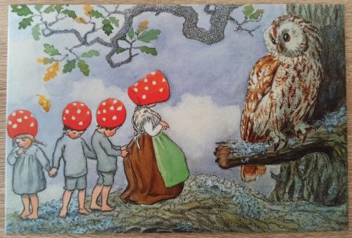 Owl and children on a wooden background. The picture is handmade.