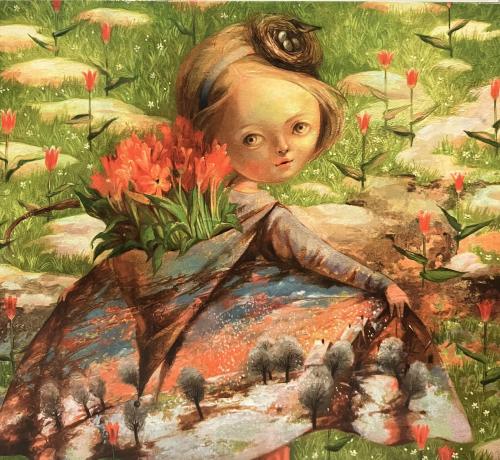 Little girl sitting on a rock in the meadow with tulips