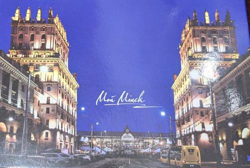Illustration of New York City street at night with neon lights.