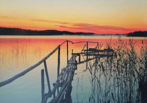 Wooden pier on the lake at sunset. Vintage postcard.