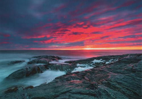 Beautiful sunset over the sea. Seascape with rocks.