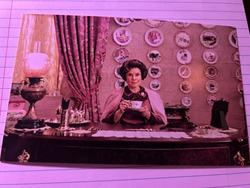 Vintage photo of a woman sitting on a table with a cup of coffee