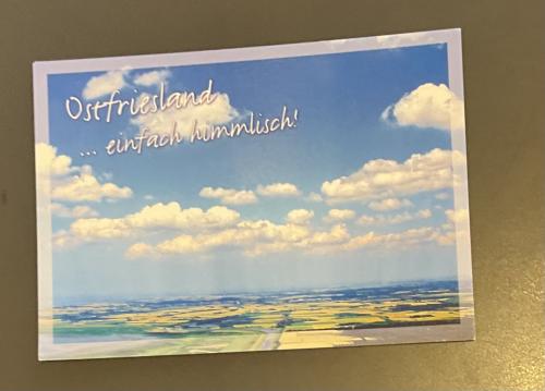 Identity card with a picture of a field and blue sky.