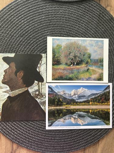 Straw hat with a picture of a man in the mountains.