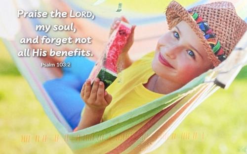 Little girl in a hammock with watermelon in her hands.