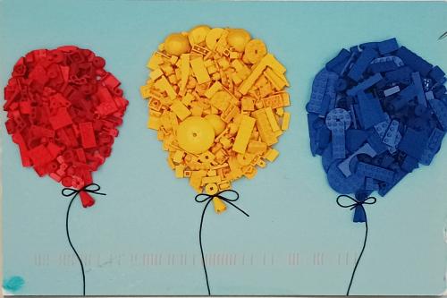 Colorful paper flowers on a blue background. The concept of love.