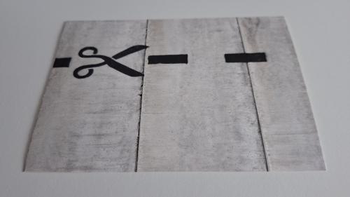 Close up of a stencil with a black and white lettering