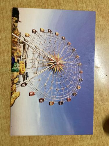 Amusement park. Ferris wheel on a background of blue sky