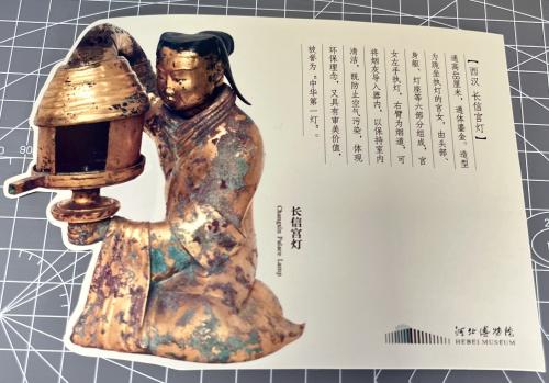 Korean traditional copper sculpture of a man with a lantern in his hand