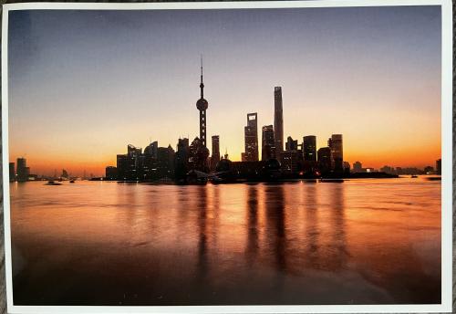 Shanghai skyline at sunset, China. Vintage postcard.