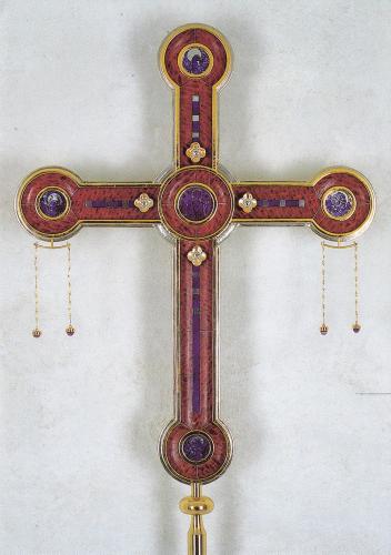 Old wooden cross on a white background. The cross is decorated with precious stones.