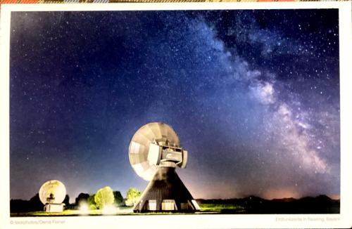 USSR - CIRCA 1980s: An antique photo of a satellite dish and the Milky Way
