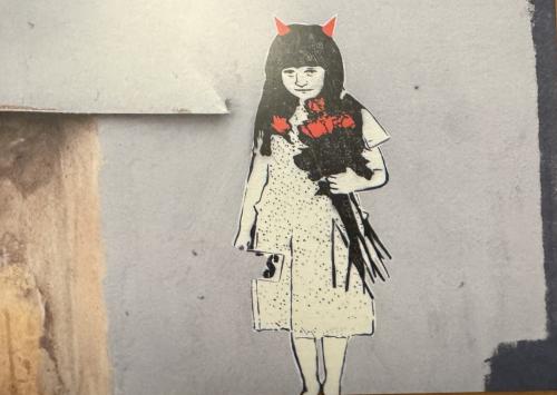 Fashionable Japanese girl with horns on the background of the wall