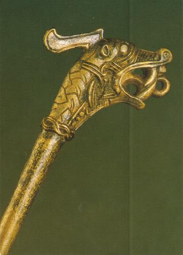 Vintage image of a wooden walking stick with a metal handle.