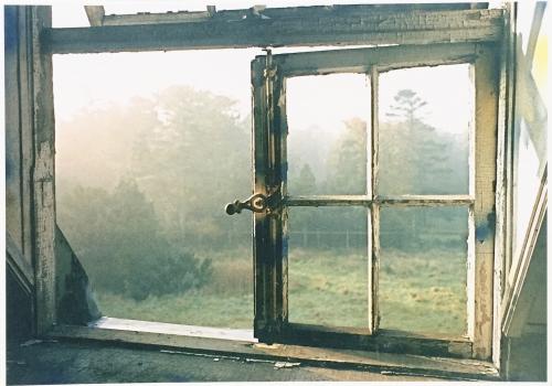 Vintage photo of old window in the foggy morning. Retro style.