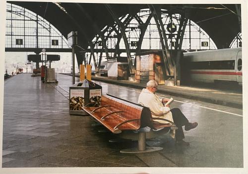 USSR - CIRCA 1980s: A postcard printed in the USSR shows a man reading a book in the railway station, circa 1980s