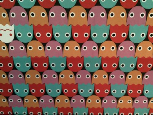 Seamless pattern of colorful paper owls on white background.