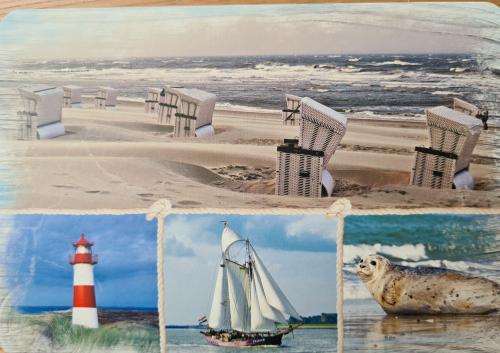 Sailboat, lighthouse and old postcard on the seashore
