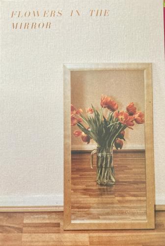 Vase with tulips on the wooden floor. Vintage style.