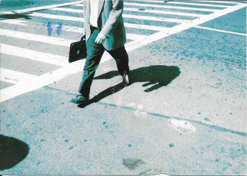 Businessman walking on the crosswalk in the city. Business concept