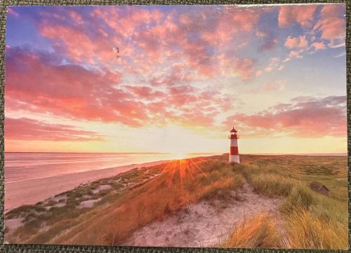 Lighthouse on the beach at sunset. Collage. Photo.