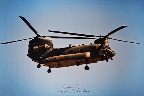 Military helicopters flying in the blue sky.  Vintage style image.