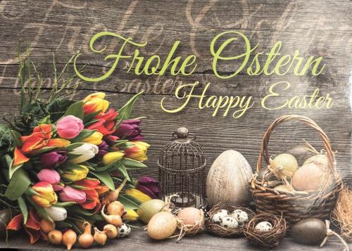 Easter eggs and tulips on wooden background. Happy Easter greeting card.