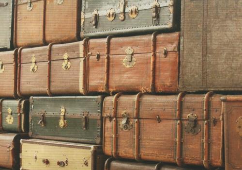 Vintage brown suitcases in a row, close-up.