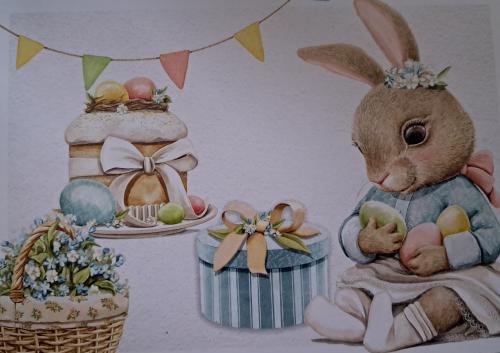 Easter decoration with rabbit, eggs, cake and a basket of flowers