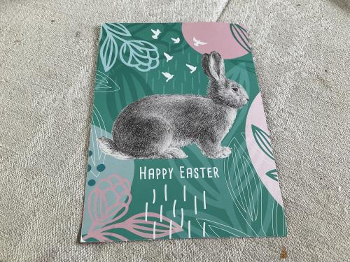 Easter greeting card with a rabbit on a concrete background. Happy Easter.