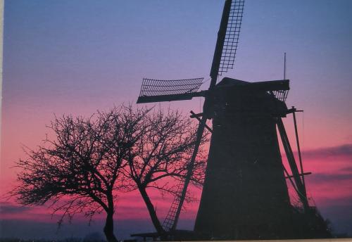 Old windmill at sunset, Holland, Europe. Vintage photo.