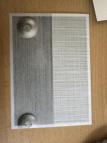 A vertical shot of a metal plate on a wooden surface with copy space