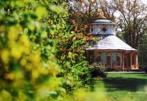 Beautiful old wooden house in the park. Vintage style photo.