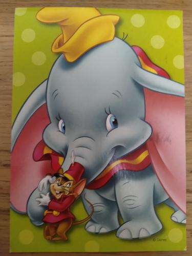 Elephant on a book on a wooden background. Children's toy.