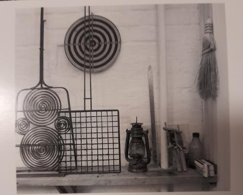 Kerosene lamp on a shelf in a museum. Black and white photo.