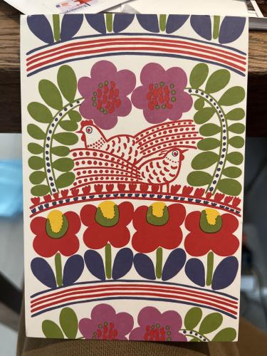 Easter card in the form of a rooster on a wooden table