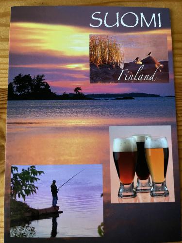 A vertical shot of a beer menu with a man fishing in the background
