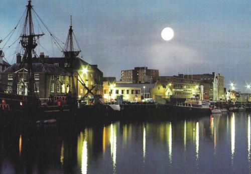Night view of the port of Gdansk in Poland with the moon