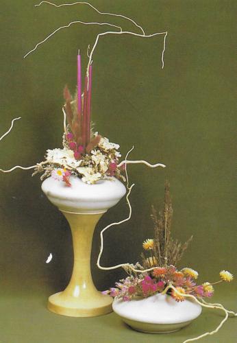 Vase with dried flowers and candles on a green background. Copy space.
