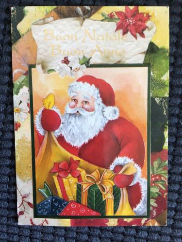 Christmas postcard of Santa Claus with gifts and poinsettia