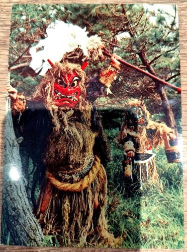 Native american indian warrior with spear and mask in the forest