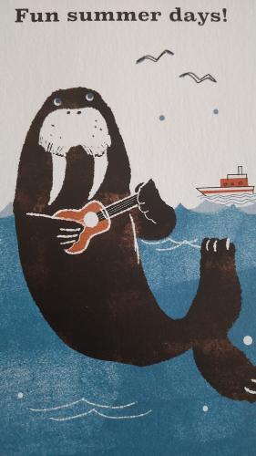 Polar bear playing the guitar on the background of the sea.