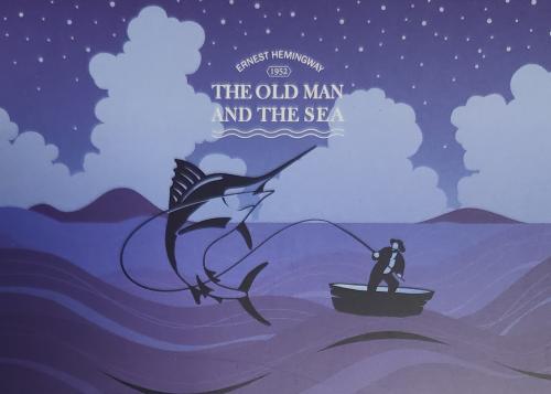 Fishing in the sea with a fisherman and a marlin.