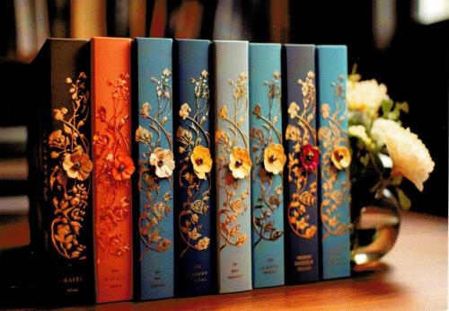 Books in a row on a shelf in a book store with flowers