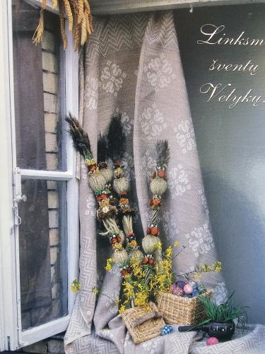 Easter decoration with wicker baskets, flowers and eggs on the window
