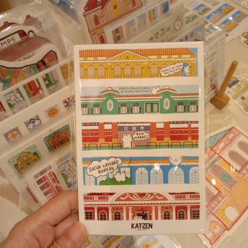 A hand holds a souvenir card from Barcelona.