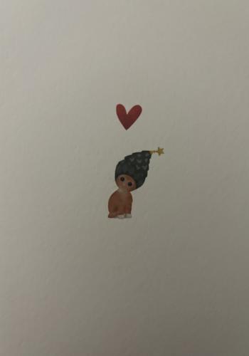 Cute little boy with a crown and a heart on the wall